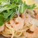 Delicious creamy shrimp pasta topped with fresh arugula and grated Parmesan cheese.